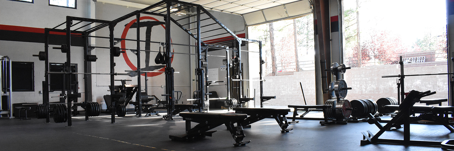 gym floor with bay doors in the back ground